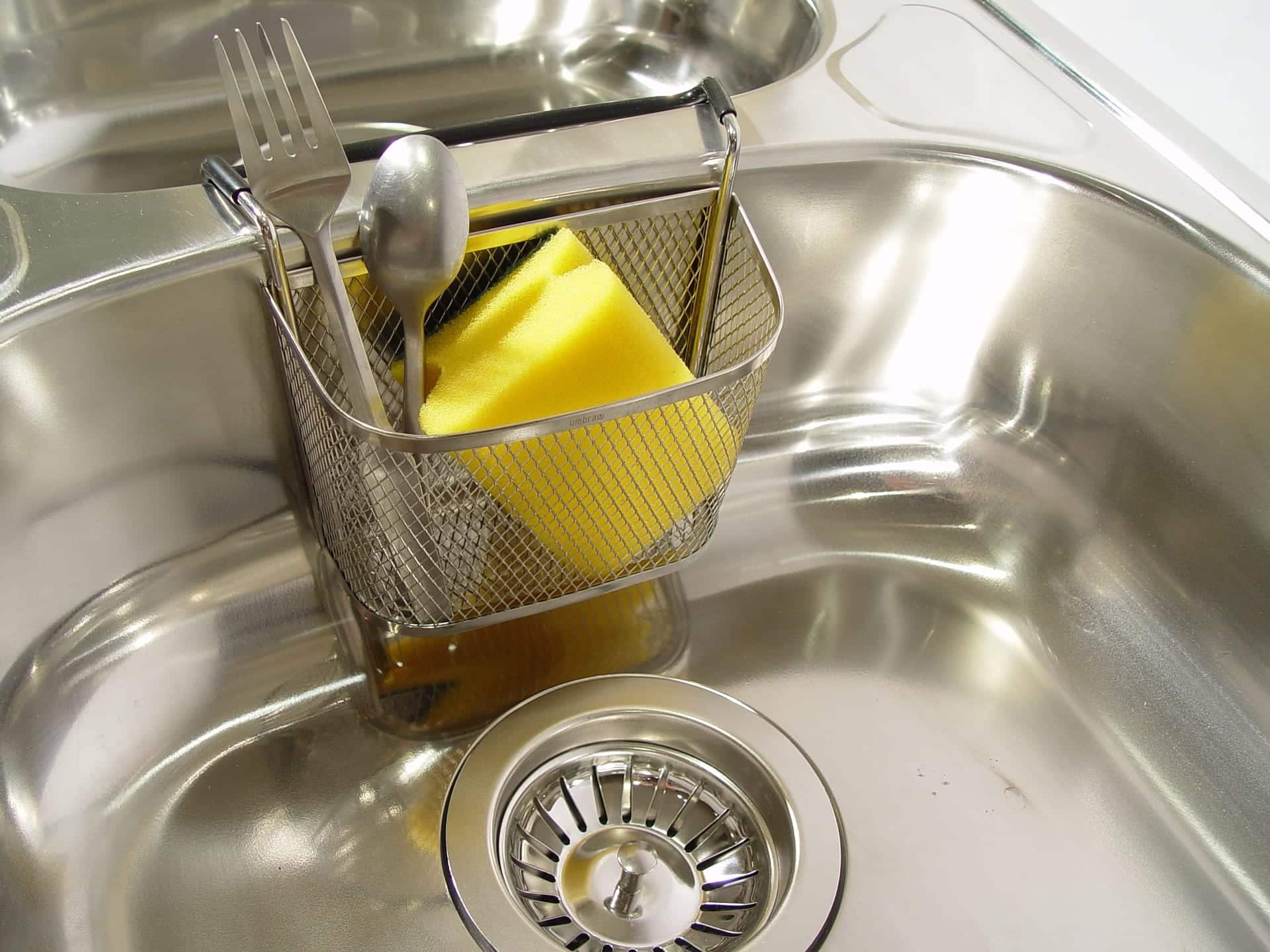 pouring chlorine down a kitchen sink